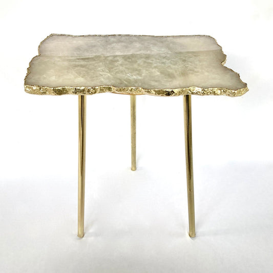 Table with a stone-like top and gold legs 